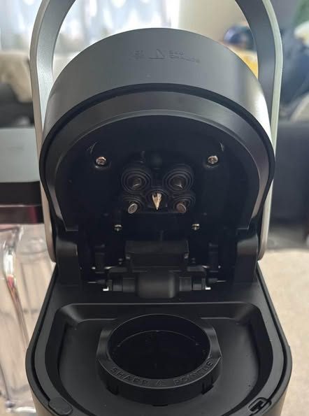 Handle up on a K-Supreme-style brewer: the entrance needles sit in the underside of the lid, above the pod holder.
