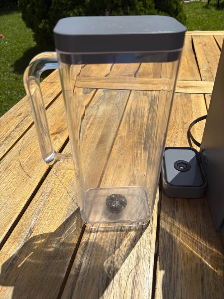 The reservoir's valve (bottom) and the socket it sits in on the base. Debris on either one can keep the tank from seating fully.