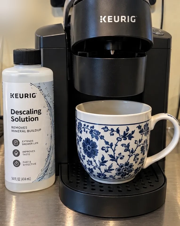 Descaling: Keurig's solution in the reservoir and a large ceramic mug on the tray for the cleansing brews.